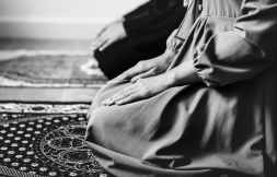 grayscale photography of woman kneeling on area rug